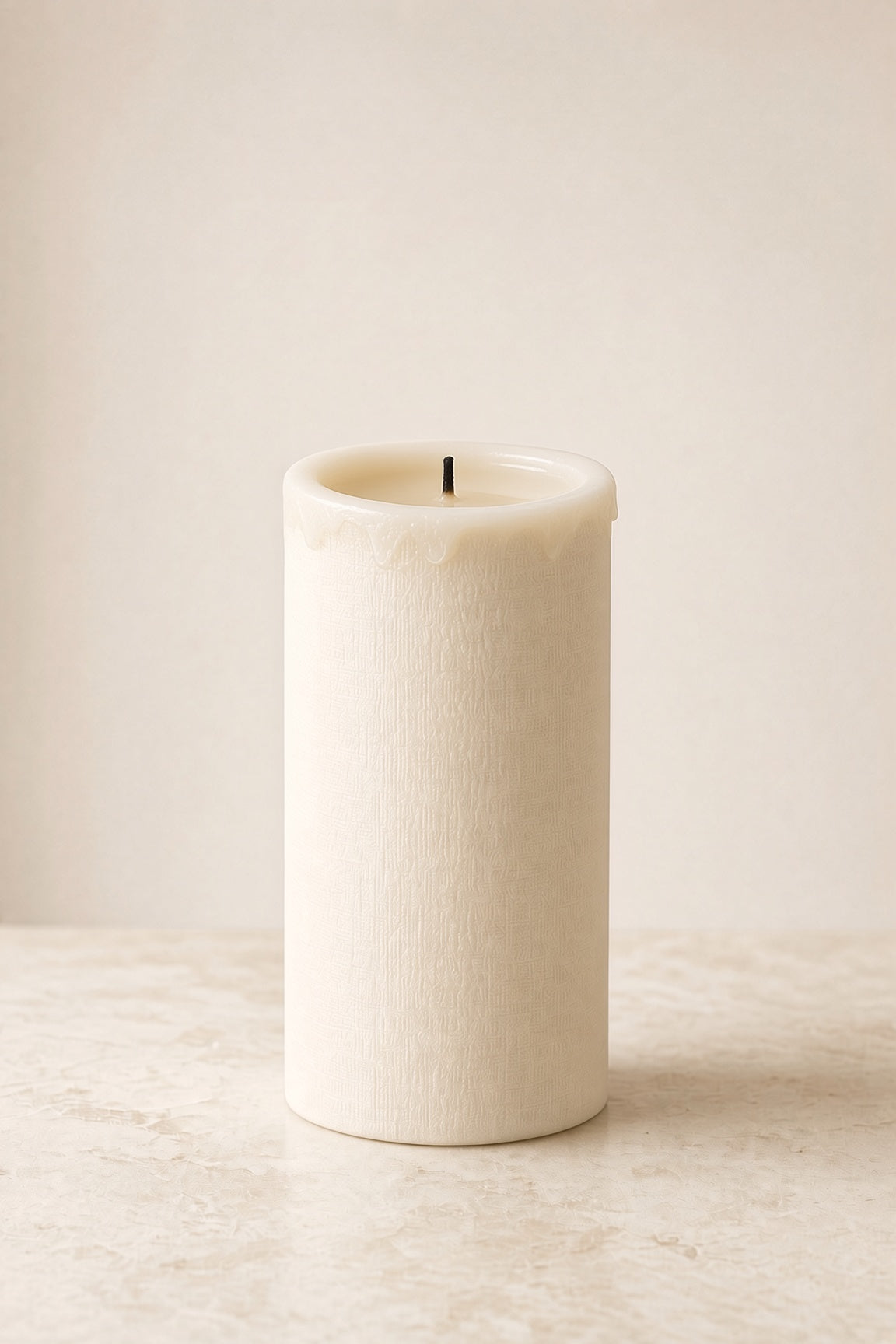 Textured white pillar candle 3x6 on cream background